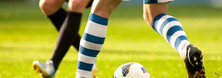 Soccer players moving toward a ball