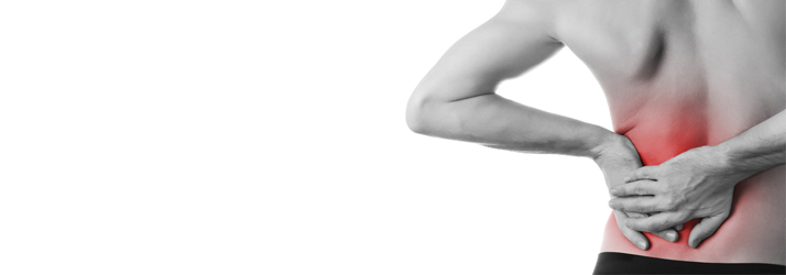A person holding their lower back, with the area highlighted in red