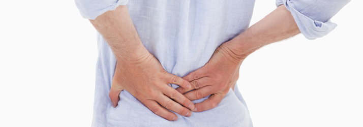 A person holding the side of their lower back