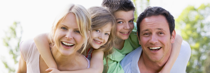Four people standing together outdoors