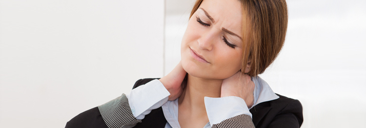 A woman holding both sides of her neck