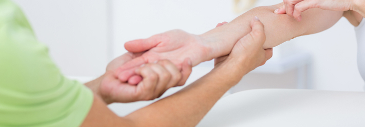 Hands supporting a wrist