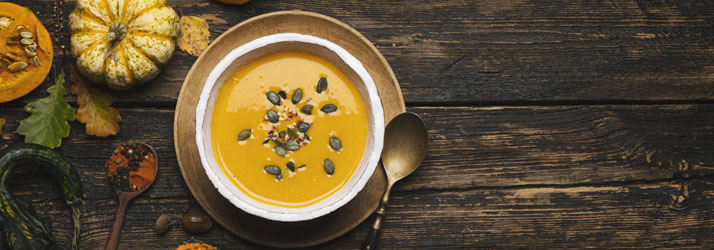 A bowl of pumpkin soup with seeds