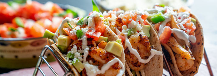 Tacos topped with vegetables and sauce